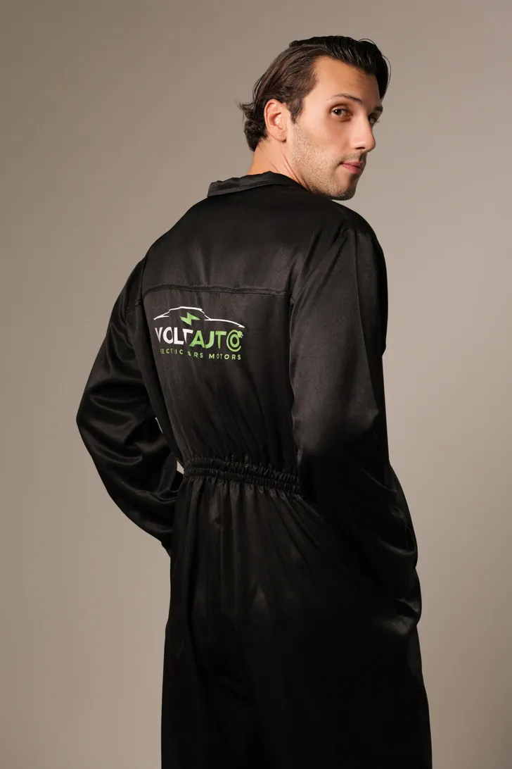 Technician in a black Volt Auto coverall