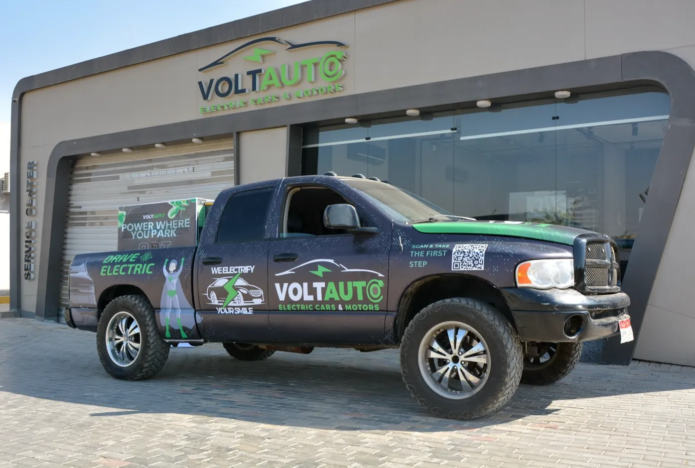 Volt Auto branded service truck outside the Volt Auto building