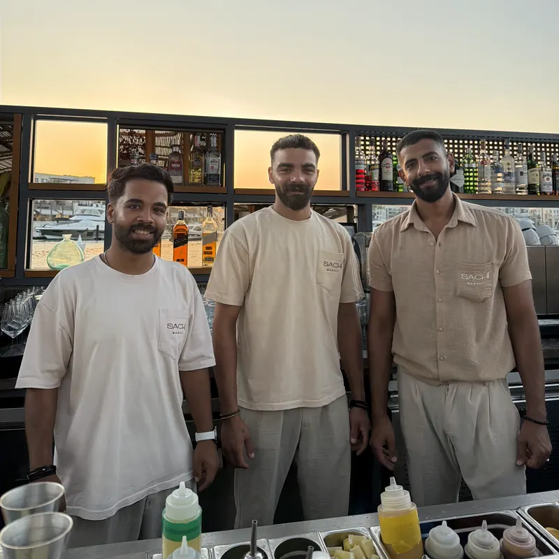 Three Sachi Marassi bar staff in beige linen shirts and tees